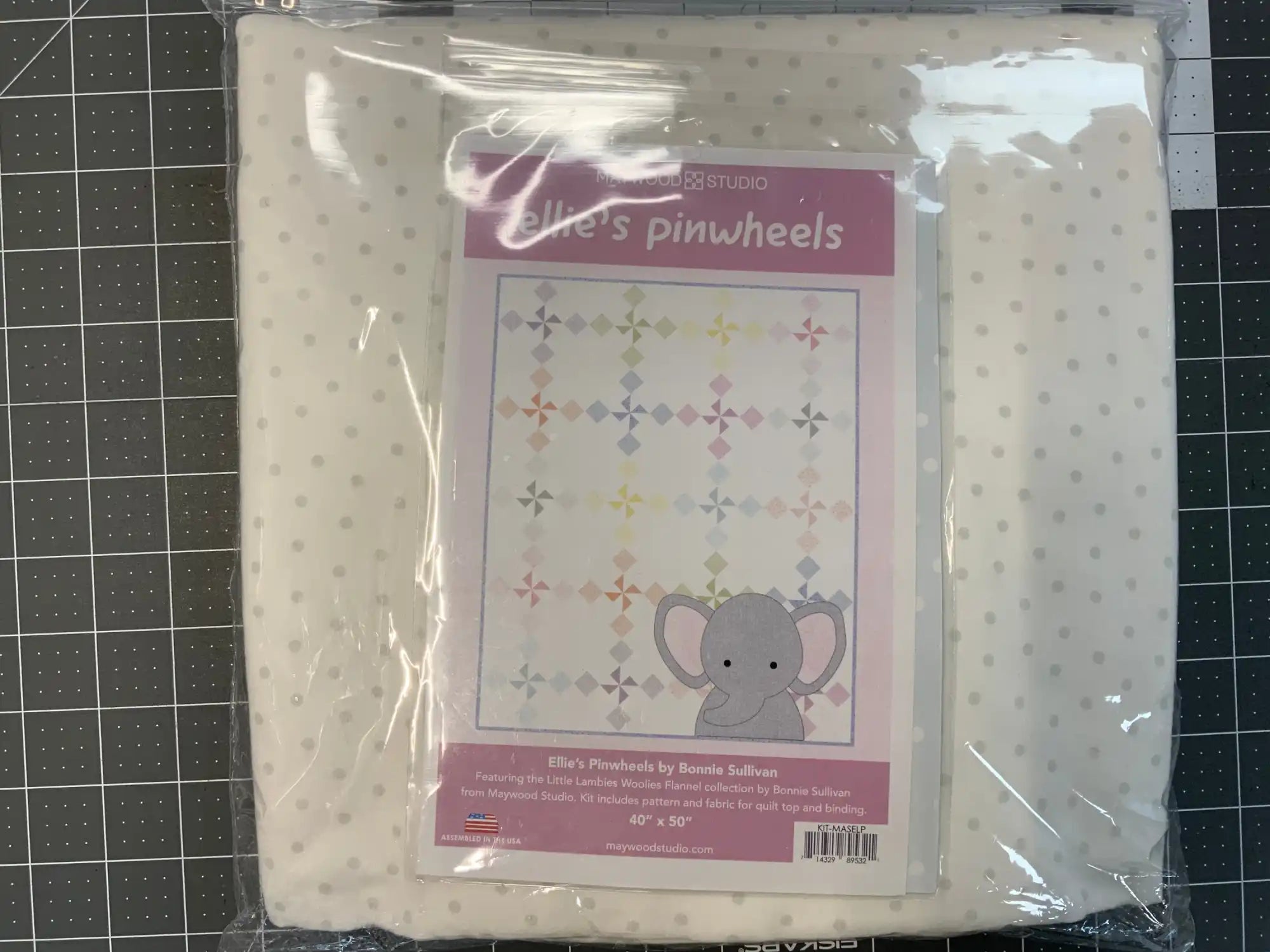 Pink and white quilt pattern featuring an elephant design in sealed packaging.